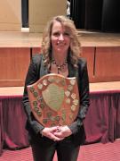 Our director happily displays our championship plaque in 2016